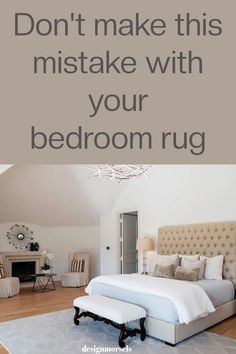 a bed room with a large white bed and a chandelier hanging from the ceiling