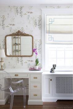 a white desk with a mirror, chair and window in the corner next to it