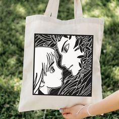 a person holding a tote bag with an image of two people