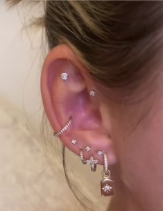 a close up of a person wearing ear piercings