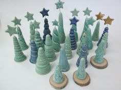 there are many small ceramic christmas trees