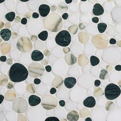 a white and green mosaic tile with black dots