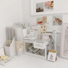 a white desk topped with lots of different types of cards and boxes on top of it