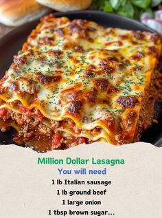 a black plate topped with lasagna covered in cheese