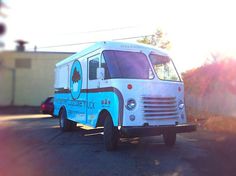 an ice cream truck is parked on the street