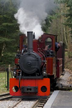 an old fashioned steam engine on the tracks