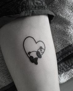 a panda bear in a heart tattoo on the leg