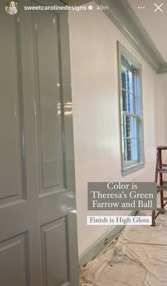 the interior of a house with white paint and green trim on the door, window, and floor