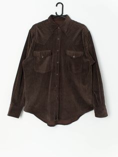 Vintage jumbo cord shirt in brown. This 90s brown jumbo cord shirt features bronze snap buttons and two chest pockets with snap closures. Can be worn as a warm shirt or as an overshirt! Made from a mid-weight soft cotton. Our recommended size: Large to XL Label says: No size label Condition: Very good  Material: No care label, confident it is cotton Measurements in inches: Pit to pit: 23.5 Shoulder to shoulder: 19 Front length: 31.5 Back length: 32.5 Sleeve: 25.5 We recommend that you compare ou Cord Shirt, Abstract Shirt, Fleece Plaid, Wool Cape, Harrington Jacket, Shetland Wool, Cable Knit Jumper, Sleeveless Cardigan, Vintage Soft