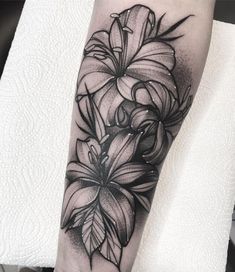 a black and white flower tattoo on the arm