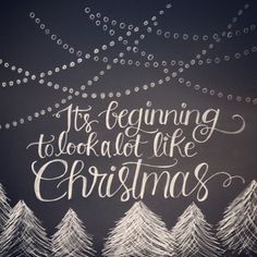 a chalkboard with the words it's beginning to look at like christmas trees