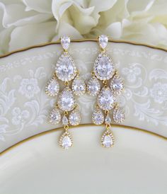 "Beautiful cascading waterfall teardrop earrings are a perfect accessory for bride or bridesmaid. Created with Swarovski Pure Brilliance stones in 3 different finishes. Available in rhodium, rose gold and yellow gold Earrings measure 2-1/2\" x 7/8\" Matching pieces: https://www.etsy.com/listing/674474135/rose-gold-bridal-bracelet-teardrop?ref=shop_home_active_1&pro=1&frs=1 https://www.etsy.com/listing/273104988/rose-gold-necklace-bridal-necklace?ref=shop_home_active_33 https://www.etsy.c Glamorous Drop Chandelier Earrings For Anniversary, Gold Drop Chandelier Earrings For Anniversary, Gold Long Drop Chandelier Earrings For Wedding, Glamorous Gold Drop Bridal Earrings, Glamorous Drop Chandelier Earrings For Wedding, Pear-shaped Chandelier Earrings For Wedding, Gold Long Drop Bridal Earrings For Wedding, Glamorous Wedding Drop Chandelier Earrings, Glamorous Long Drop Bridal Earrings For Wedding