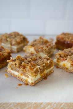 several pieces of dessert sitting on top of a piece of parchment paper next to each other