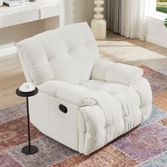 a white recliner sitting on top of a rug