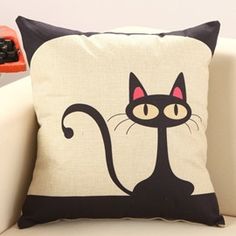 a black and white pillow with a cartoon cat on it's side, in front of a white background