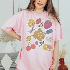 Step into a whimsical world with our Cottagecore Clothes Vintage Fruity Shirt. This preppy and cheerful garment features a delightful array of fruits, making it a perfect choice for those who love all things foodie and fruity. Crafted with comfort in mind, this Fruit T-Shirt is designed using high-quality, vegan materials that embrace the essence of nature. The vibrant colors and charming design of this Fruit Tee offer an aesthetic appeal that is both eye-catching and playful. Whether you're loo Summer Nyc Outfits, Casual Church Outfits Summer, Summer Work Outfits Office Casual, Summer Bar Outfits, Dinner Outfits Summer, Summer Work Outfits Office, Nyc Outfits Summer, Summer Camping Outfits, Church Outfit Casual