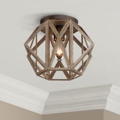 a wooden light fixture hanging from the ceiling