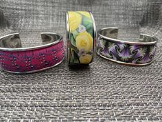 Handmade silver tone adjustable cuff bracelet with polymer clay design.  Choose from abstract design pink, paragon twist purple or yellow roses and daisies Spring Gift Cuff Bracelet, Spring Gift Adjustable Cuff Bracelet, Adjustable Spring Cuff Bracelet As Gift, Adjustable Spring Cuff Bracelet Gift, Hand Painted Jewelry As Spring Gift, Hand Painted Jewelry For Spring Gift, Adjustable Hand Painted Bangle Jewelry, Adjustable Wearable Art Cuff Bracelet Gift, Unique Adjustable Pink Cuff Bracelet