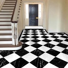 a black and white checkered floor in an empty house with stairs leading up to the door