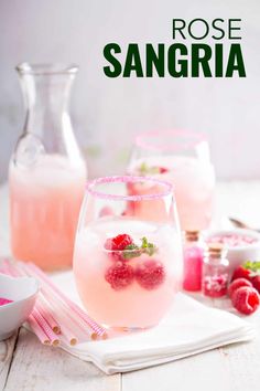 raspberry rose sangria in glasses with strawberries on the rim and pink napkins