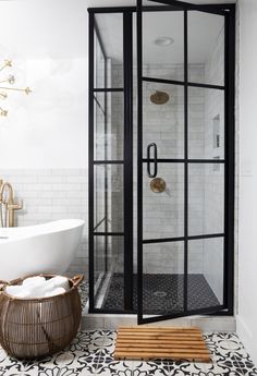 a black and white bathroom with a glass shower door