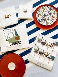 the table is set with construction themed napkins and placemats, which are also on plates