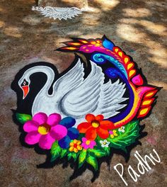 a white swan painted on the ground with flowers