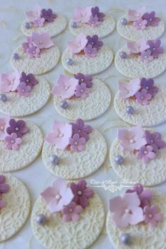 some pink and purple flowers on white doily