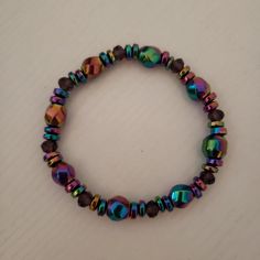 The Rainbow Hematite Bracelet has tiny amethyst beads and fits a 7-inch approximately. Adjustable Iridescent Crystal Bracelet With Faceted Beads, Hematite Bracelet With 8mm Beads, Adjustable Amethyst Jewelry With Colorful Beads, Iridescent Beaded Bracelets With Colorful Beads As Gift, Gift Iridescent Beaded Bracelets With Faceted Beads, Iridescent Beaded Bracelets As Gift, Iridescent Bracelets With Faceted Beads, Iridescent Faceted Beaded Bracelets As Gift, Iridescent Faceted Beads Bracelet As Gift