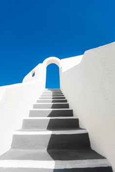 the steps lead up to an arch in the sky