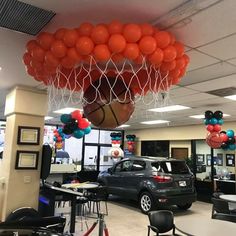 an office decorated with balloons and basketballs in the shape of a ballon hanging from the ceiling