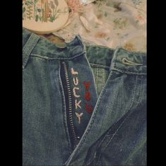 an old pair of jeans with the word lucky written on it