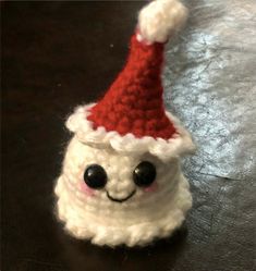 a crocheted santa hat sitting on top of a table