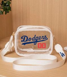 Clear Dodgers bag perfect for games or any occasion White Clear Plastic Bag With Clear Strap, White Clear Plastic Bag For Daily Use, Trendy White Bag In Clear Plastic, Trendy White Clear Plastic Bag, White Plastic School Bags, White School Bag With Clear Strap, Trendy Clear School Bag, Trendy Clear School Bags, Trendy White Plastic Bags