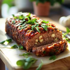 meatloaf with herbs and spices on a cutting board