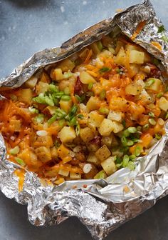 the food is prepared and ready to be eaten in the foil wrapper on the table