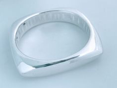 "Vintage Bat Ami Electroformed Puffed 925 Sterling Silver Squared Bangle Bracelet. Chunky geometric lines contrasted with high polish high shine silver provide a clean but bold modern look.  Stamped Maker Mark: BatAmi 925 Weight: 36 grams Size: Inside circumference 7 1/2\", Inside Diameter across 2 1/2\", Width 1/2\" at widest point.  Condition: Vintage pre-owned ready to wear. High polish finish is in very good conditon with minimal surface wear, there are a couple of small dings from wear.  Se Contemporary Sterling Silver Bangle Bracelet, Elegant Silver Square Bracelet, Contemporary Sterling Silver Bangle Bracelet Gift, Contemporary Sterling Silver Bracelet Gift, Contemporary Sterling Silver Bracelet As Gift, Contemporary Sterling Silver Bangle Bracelet For Formal Events, Contemporary Sterling Silver Bangle For Formal Occasions, Modern Sterling Silver Rectangular Bracelet For Formal Events, Silver Bangle Bracelets Cuffs