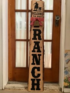 a welcome to our ranch sign in front of a door