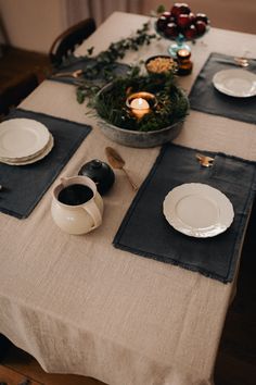 the table is set with dishes and place settings