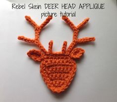 an orange crocheted deer head on a piece of paper with the words red skin deer head applique