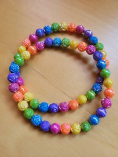 Show your LGBTQ+ pride with this bright, colorful, and cheerful bracelet set.  This beaded bracelet set comes with 2 stretch bracelets, both are 9 inches long.  Beads feature roses with a rainbow shine on them.  These vibrant rainbow bracelets are lightweight. Please keep bracelets away from moisture. Why we're worth it: we show pride, are lightweight, and look great on you! Bracelets come gift-ready in one box with free personalized hand-written message.  Please request a second box if you would like each bracelet to be in its own box. Cheap Rainbow Beaded Bracelets For Everyday, Cheap Rainbow Stretch Bracelet With Colorful Beads, Cute Rainbow Stretch Bracelet With Colorful Beads, Cute Rainbow Colorful Beads Stretch Bracelet, Cheap Rainbow Beaded Novelty Bracelets, Rainbow 8mm Beaded Bracelet, Cheap Rainbow Bracelets For Pride, Keep Bracelet, Rainbow Roses