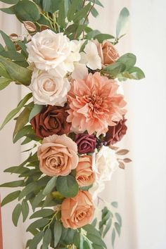 a vase filled with lots of flowers on top of a table