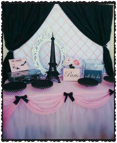 there is a pink table with black and white decorations