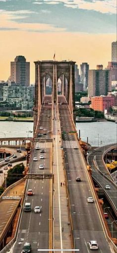 an aerial view of the brooklyn bridge in new york city, with cars driving on it