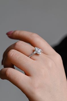 a woman's hand with a diamond ring on it