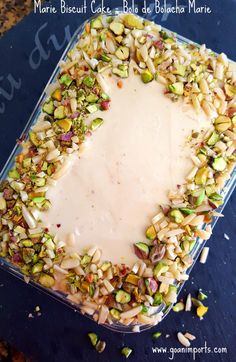 a square cake with nuts and cream frosting