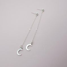 SOLID STERLING SILVER EARRINGSThese celestial earrings make a wonderful gift. The real sterling ear studs are adorned with a tiny moon that dangles elegantly on sterling silver chain. Comes in a gift box, perfect for gift giving. Total earring length is approximately 2 3/4 inches long. ALSO AVAILABLE IN A STAR DESIGN OR MOON/STAR COMBO Dainty Moon Phase Earrings, Sterling Silver Celestial Earrings For Gift, Adjustable Moon-shaped Minimalist Earrings, Crescent Silver Earrings As Gift, Adjustable Moon-shaped Sterling Silver Earrings, Sterling Silver Celestial Earrings For Everyday, Silver Moon-shaped Earrings For Gift, Sterling Silver Moon Phase Earrings, Dainty Hypoallergenic Moon-shaped Earrings