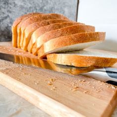 a loaf of bread sitting on top of a cutting board