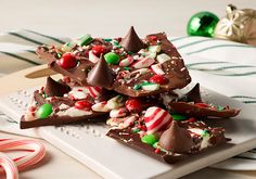 a white plate topped with pieces of candy canes and chocolate barkle crackers