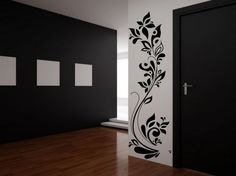 an empty room with black and white wallpaper, two doors and a wooden floor